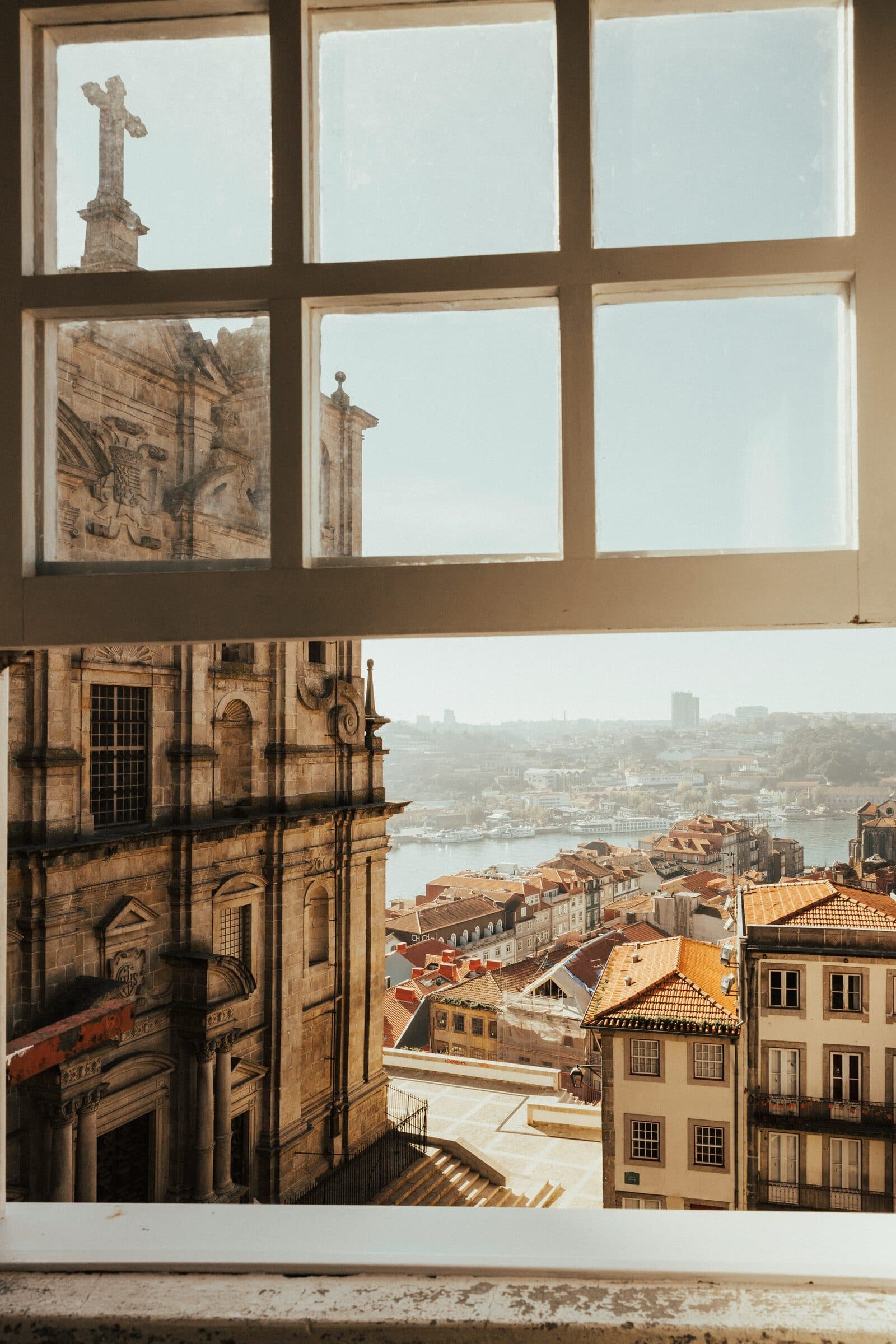 View over Porto rooftops through an old window